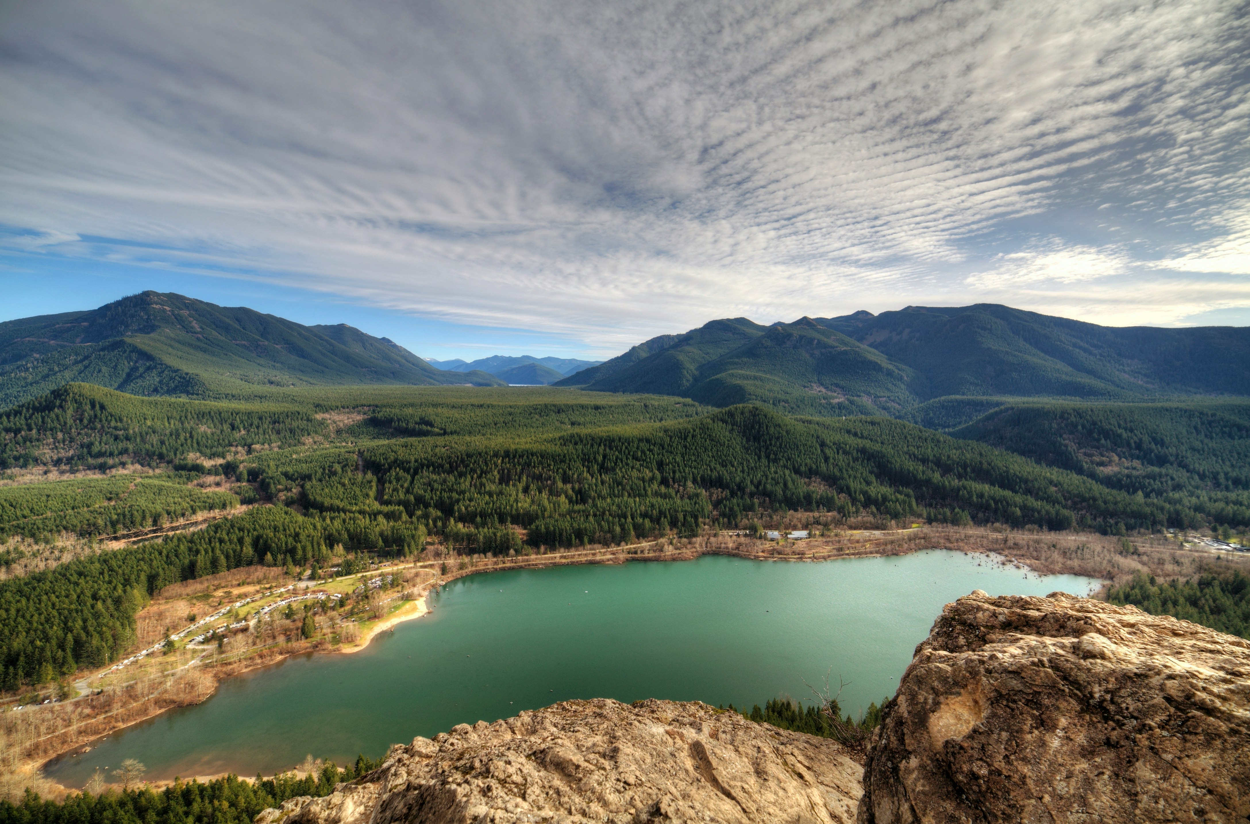 body of water near mountain peak